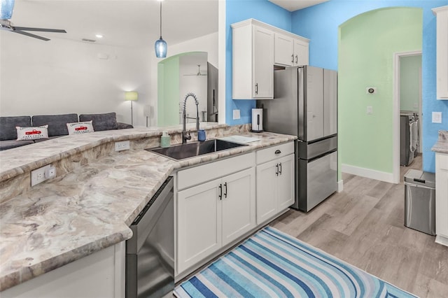 kitchen featuring white cabinetry, appliances with stainless steel finishes, sink, and ceiling fan