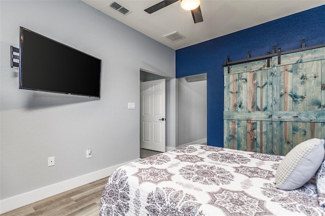 bedroom with hardwood / wood-style floors and ceiling fan