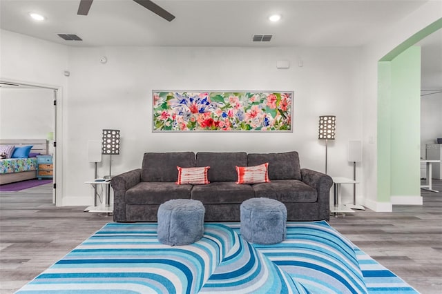 living room featuring hardwood / wood-style flooring and ceiling fan