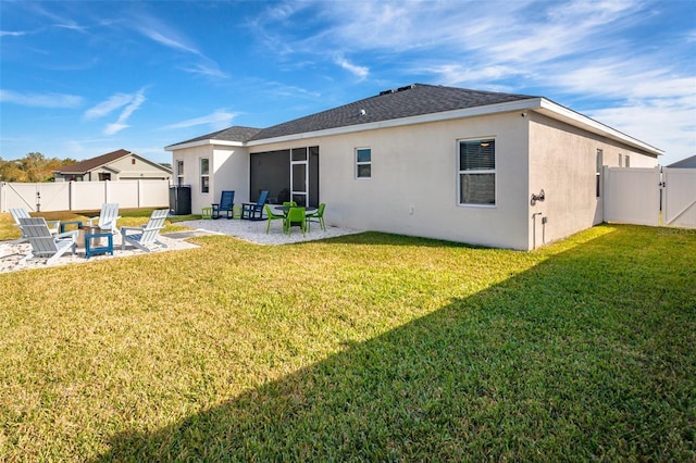 rear view of property with a yard and a patio