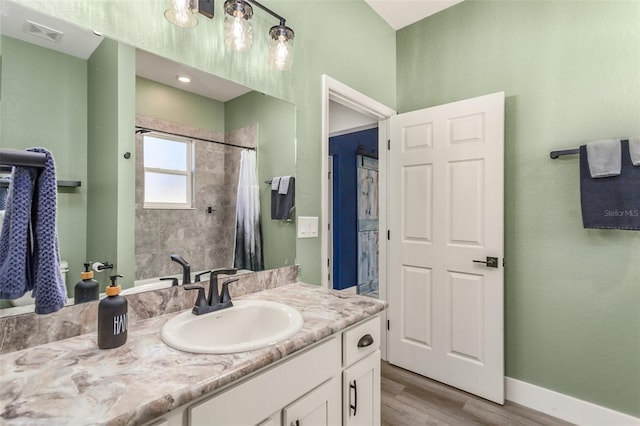 bathroom with vanity, hardwood / wood-style floors, and walk in shower