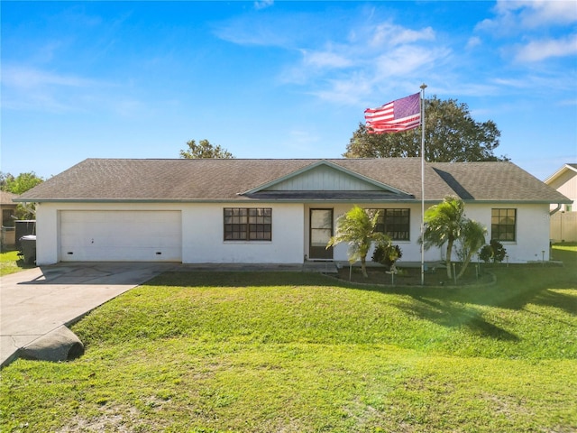 ranch-style house featuring a garage and a front lawn