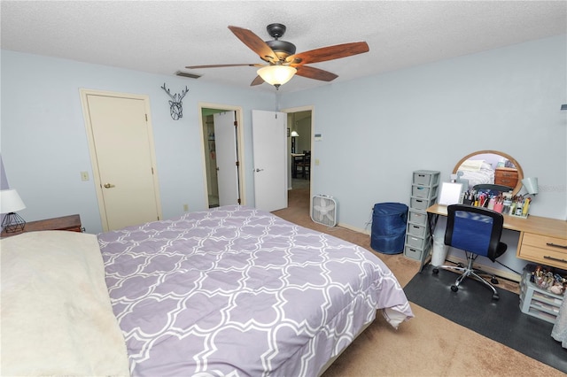 bedroom featuring carpet, ceiling fan, and a textured ceiling