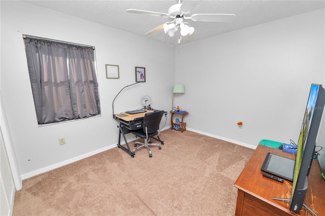 carpeted home office featuring ceiling fan and a textured ceiling