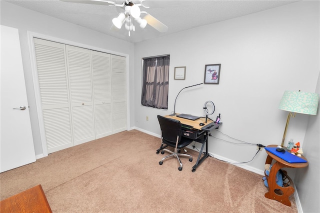 carpeted office with ceiling fan and a textured ceiling