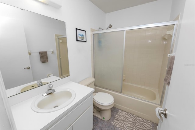 full bathroom with tile patterned flooring, vanity, toilet, and shower / bath combination with glass door