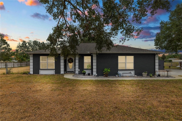 ranch-style home featuring a yard