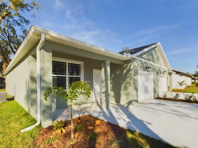 view of home's exterior featuring a garage and cooling unit