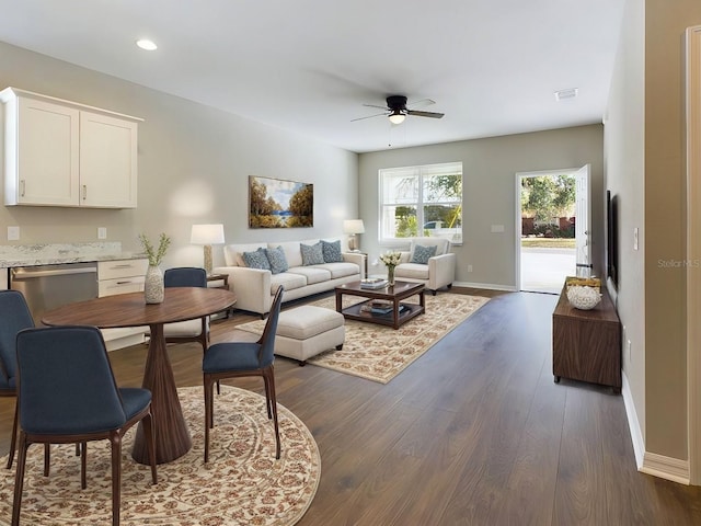 living room with dark hardwood / wood-style floors and ceiling fan