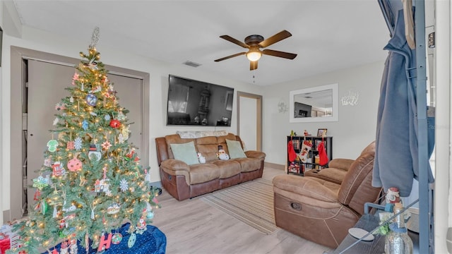 living room with ceiling fan and light hardwood / wood-style flooring