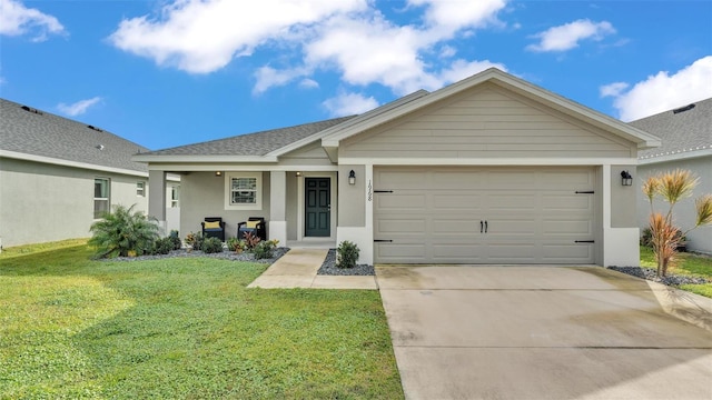 ranch-style house featuring covered porch, a garage, and a front lawn