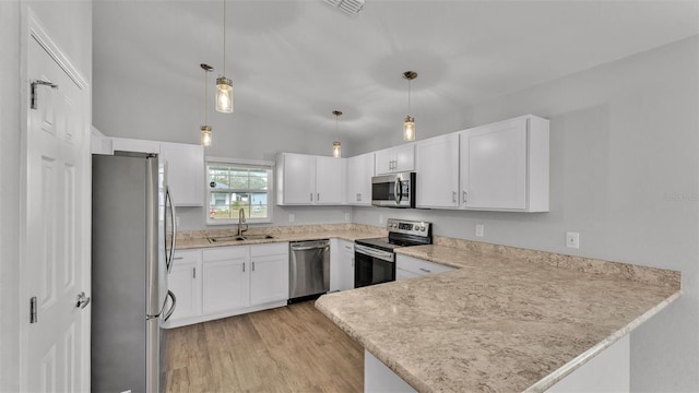 kitchen featuring kitchen peninsula, sink, hanging light fixtures, and appliances with stainless steel finishes