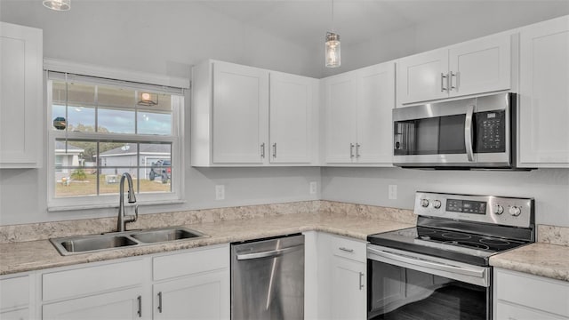 kitchen featuring white cabinets, sink, and appliances with stainless steel finishes