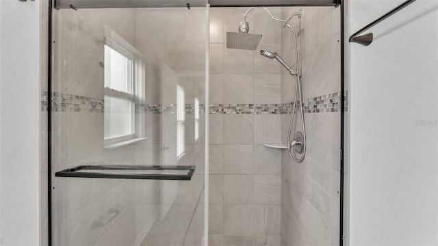 bathroom with a shower with shower door