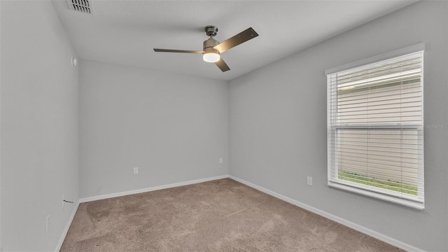 carpeted empty room featuring ceiling fan