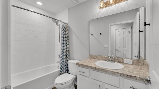 full bathroom featuring shower / bath combo, vanity, and toilet