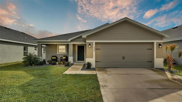 single story home with a yard and a garage