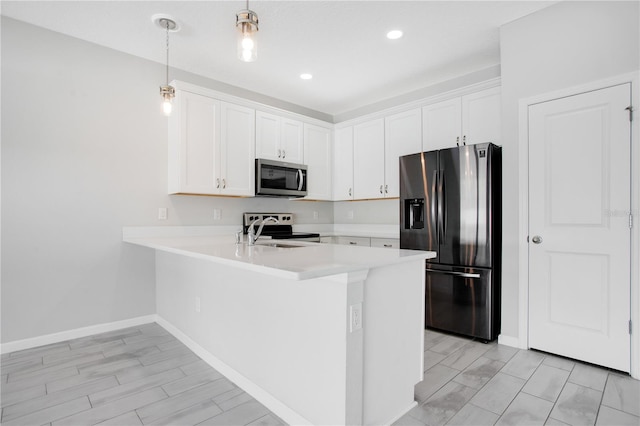 kitchen with pendant lighting, light wood-type flooring, white cabinetry, kitchen peninsula, and stainless steel appliances