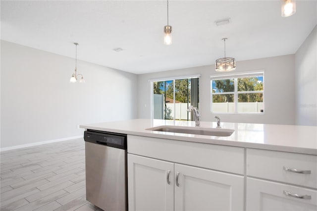 kitchen featuring dishwasher, sink, hanging light fixtures, light hardwood / wood-style flooring, and white cabinetry