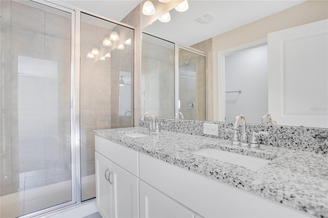 bathroom with vanity and a shower with shower door