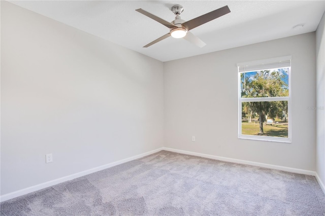 spare room featuring carpet flooring and ceiling fan