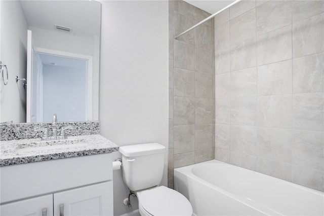 full bathroom with vanity, toilet, and tiled shower / bath