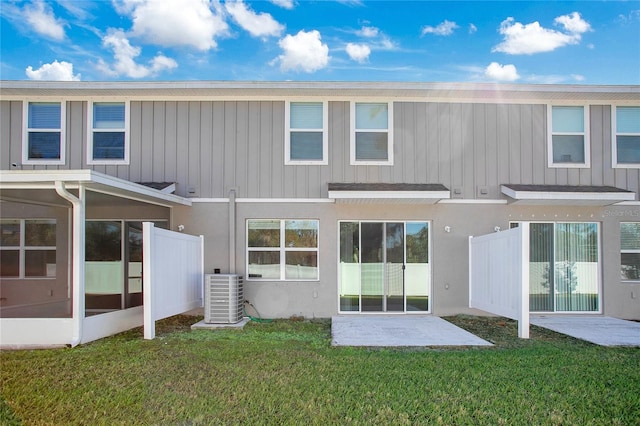 back of house featuring a yard, a patio, and central AC