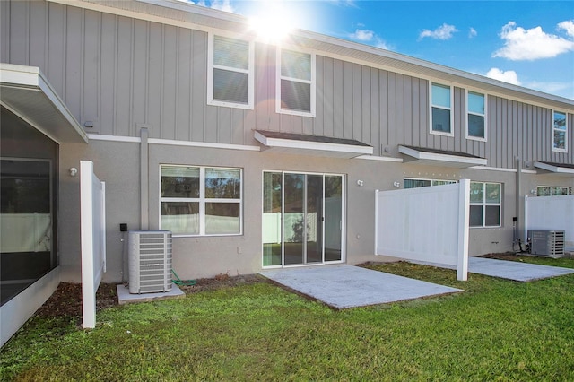 back of house with a yard, cooling unit, and a patio area