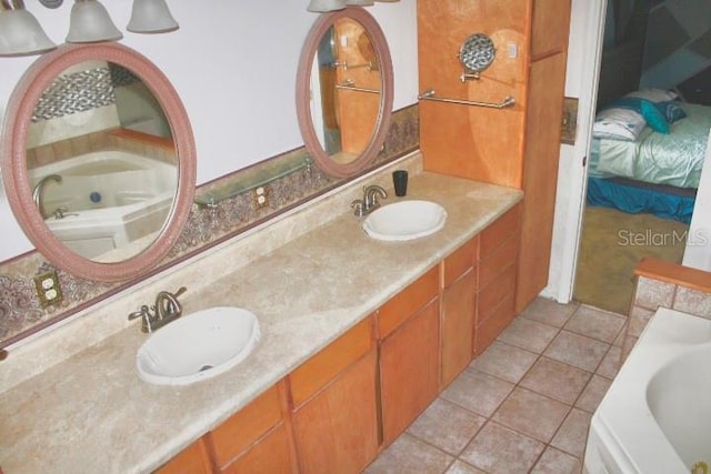 bathroom featuring a tub to relax in, tile patterned flooring, and vanity