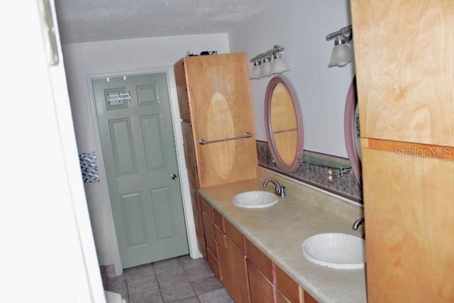 bathroom with vanity and a textured ceiling