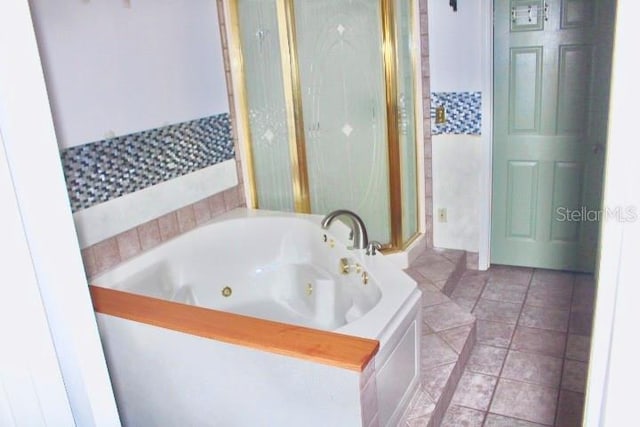 bathroom featuring tile patterned flooring and separate shower and tub