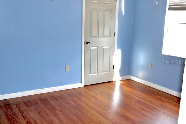 empty room featuring wood-type flooring