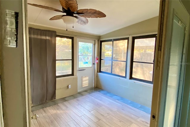 unfurnished sunroom with vaulted ceiling and ceiling fan