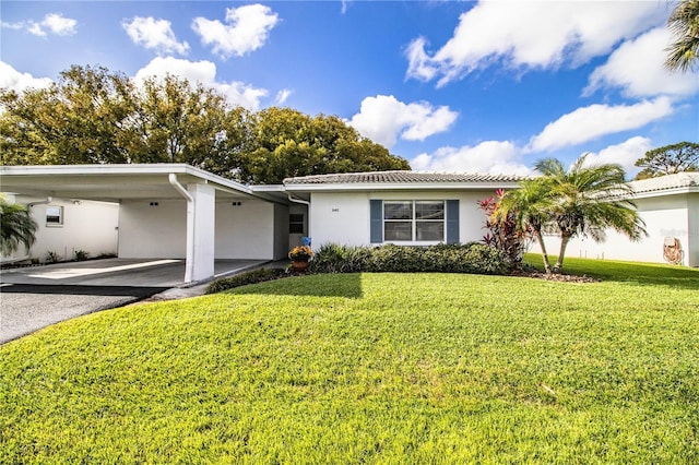 ranch-style house featuring a carport and a front lawn