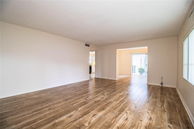 spare room featuring wood-type flooring