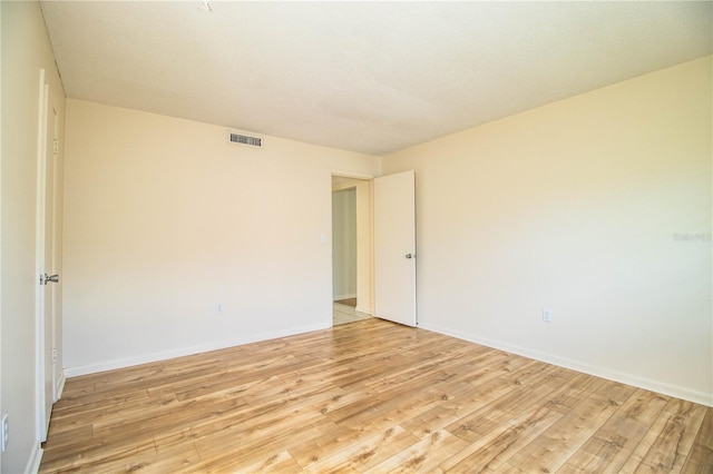 unfurnished room with light wood-type flooring