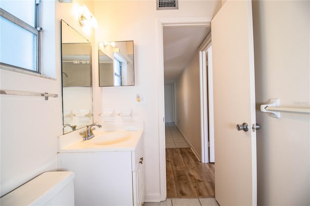 bathroom featuring tile patterned floors, vanity, a textured ceiling, and toilet