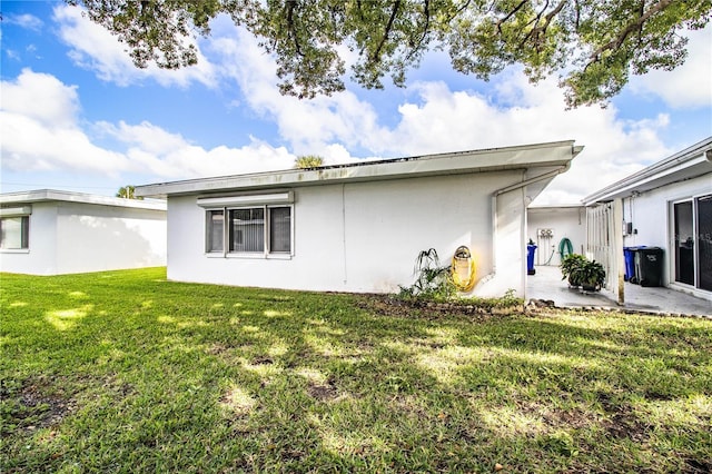 view of side of home with a lawn