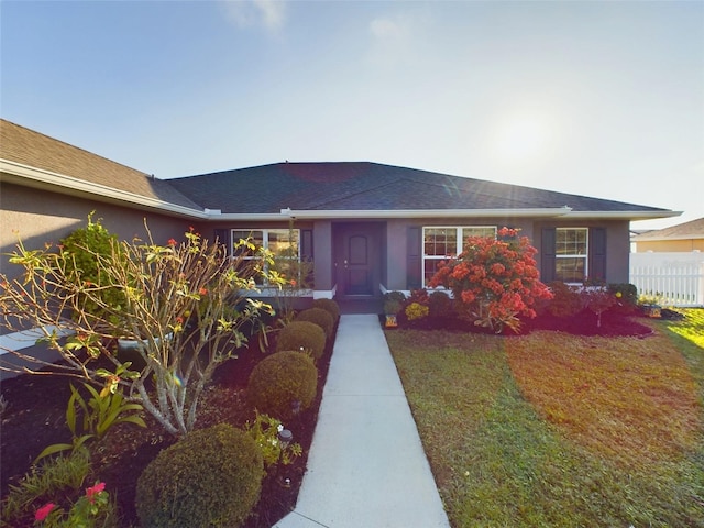 ranch-style house with a front lawn