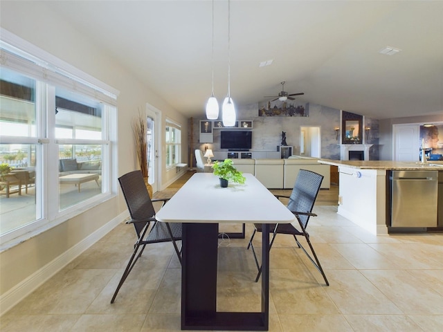 tiled dining area featuring lofted ceiling and ceiling fan