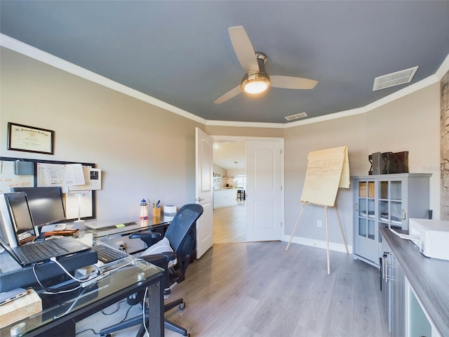 office space with crown molding, ceiling fan, and light hardwood / wood-style flooring