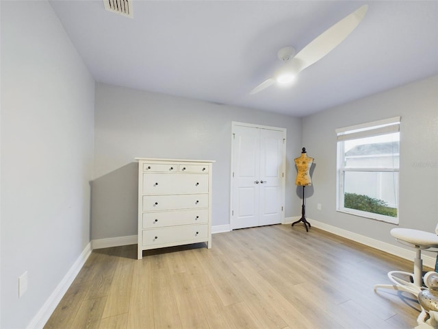 interior space featuring ceiling fan, a closet, and light wood-type flooring