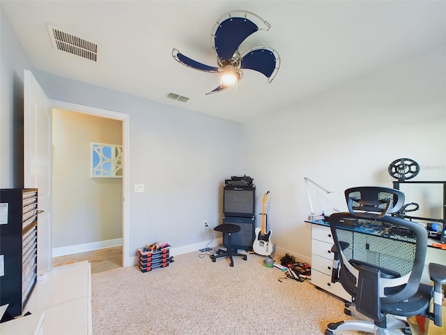 carpeted office featuring ceiling fan