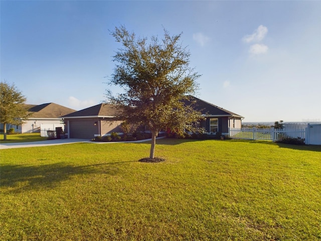 single story home with a garage and a front lawn