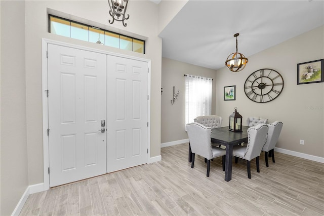 foyer entrance featuring light wood-type flooring and a chandelier