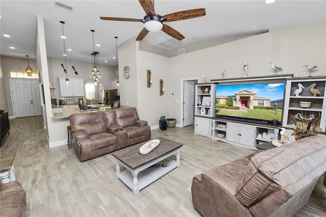 living room featuring ceiling fan and light hardwood / wood-style flooring