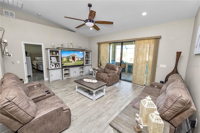 living room featuring ceiling fan, vaulted ceiling, and light hardwood / wood-style flooring