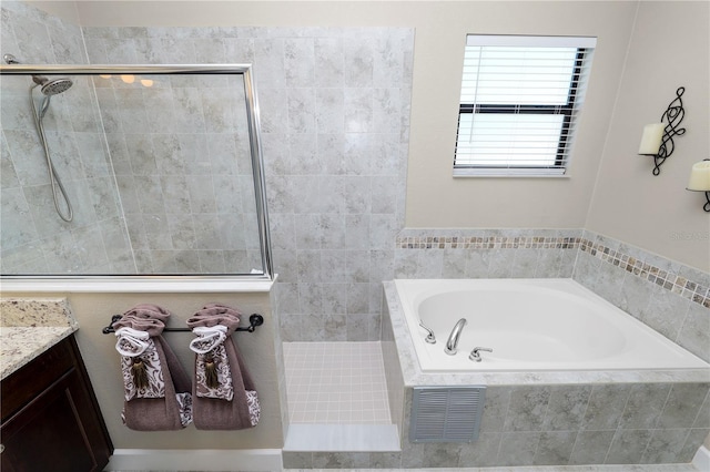 bathroom with plus walk in shower and vanity