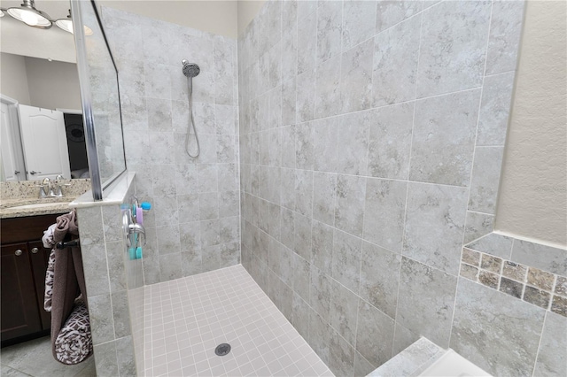 bathroom featuring vanity and a tile shower