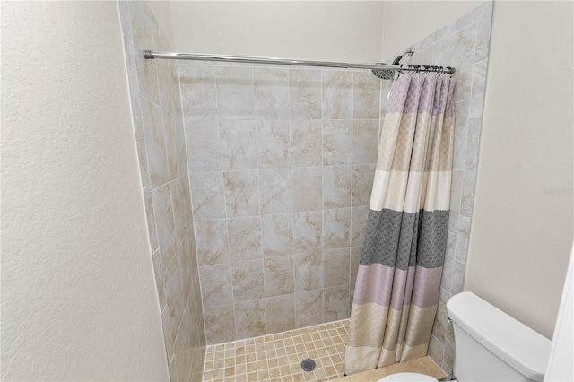 bathroom with a shower with curtain and toilet